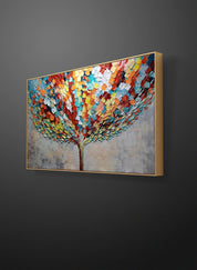 a painting of a colorful tree hanging on a wall