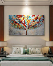 a painting called New Prosperity of a tree on a wall above a bed