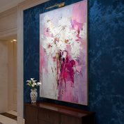 Abstract painting in a room with blue walls and a wooden cabinet.