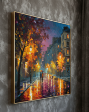 Framed painting of a city street at night with colorful lights and a person with an umbrella.